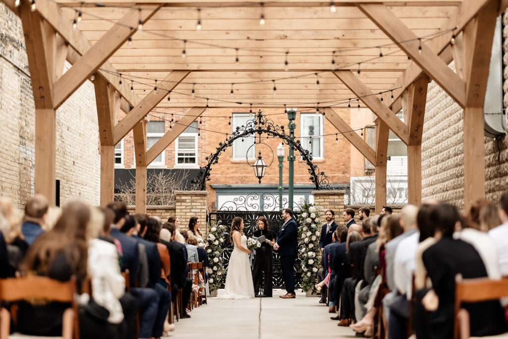 Outdoor wedding ceremony in The Urb Garden at Mercantile Hall in Burlington, WI.