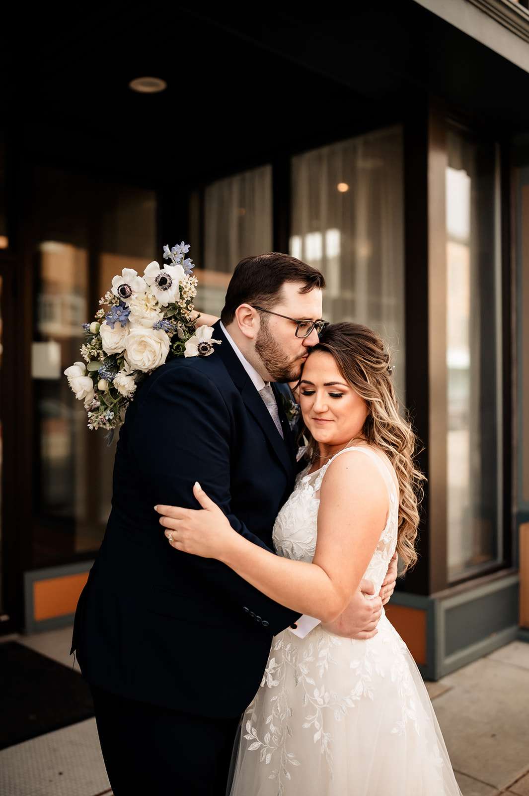 Bride and groom posing for newlywed photos for a spring wedding at Mercantile Hall in Burlington, WI.