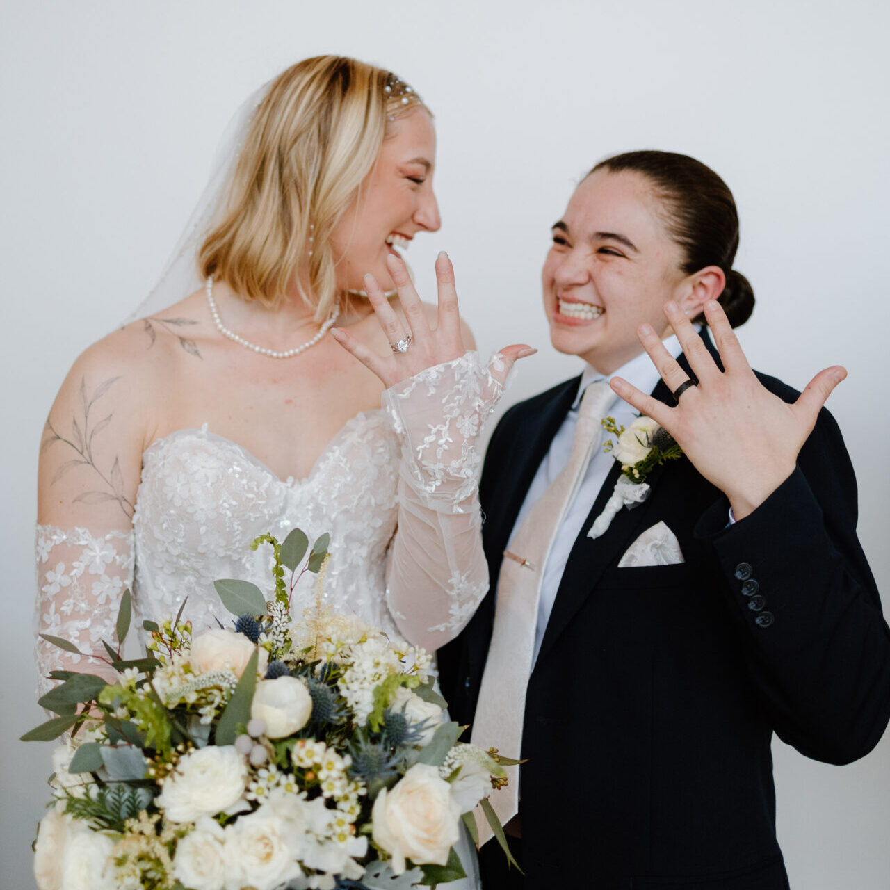 Newlyweds show off their wedding rings.