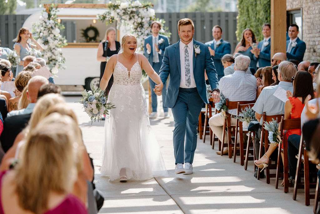 Newlyweds celebrating after their wedding ceremony in The Urb Garden.