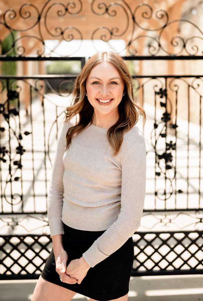 Ashlyn, Content Creation Specialist, in front of The Urb Garden gate.