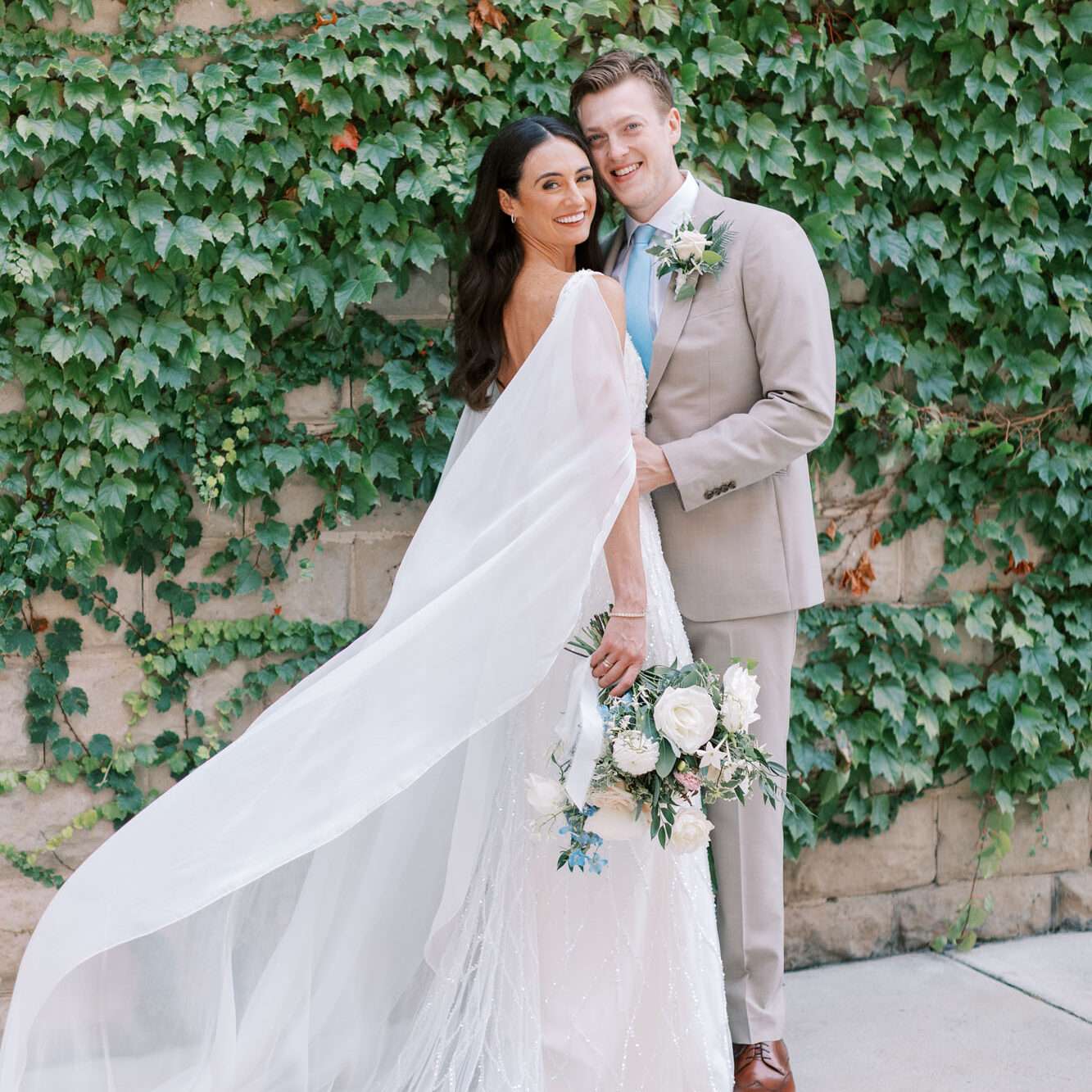 Newlyweds posing in front of the vine wall in The Urb Garden.