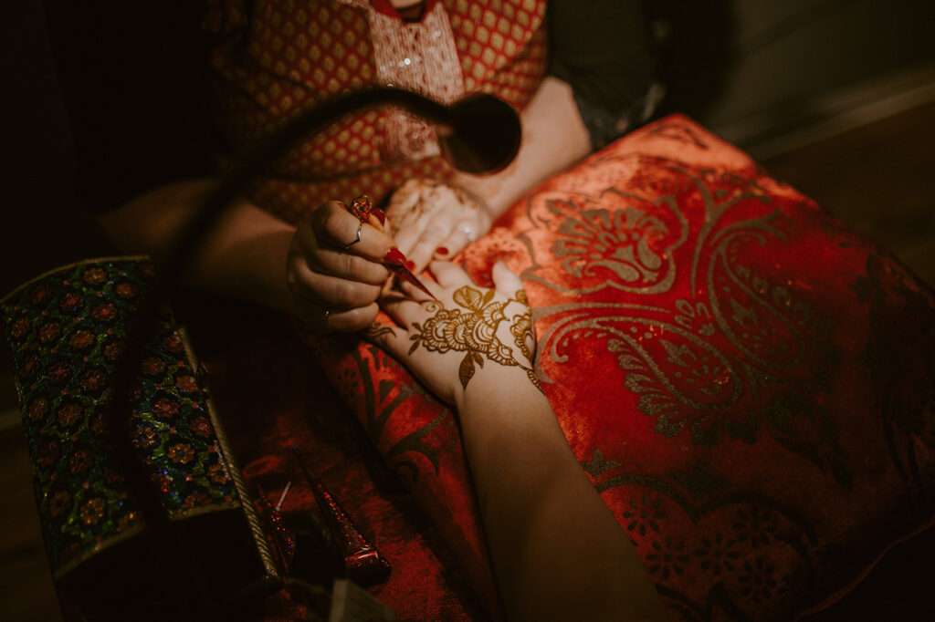 Henna artists during a wedding reception at Mercantile Hall.