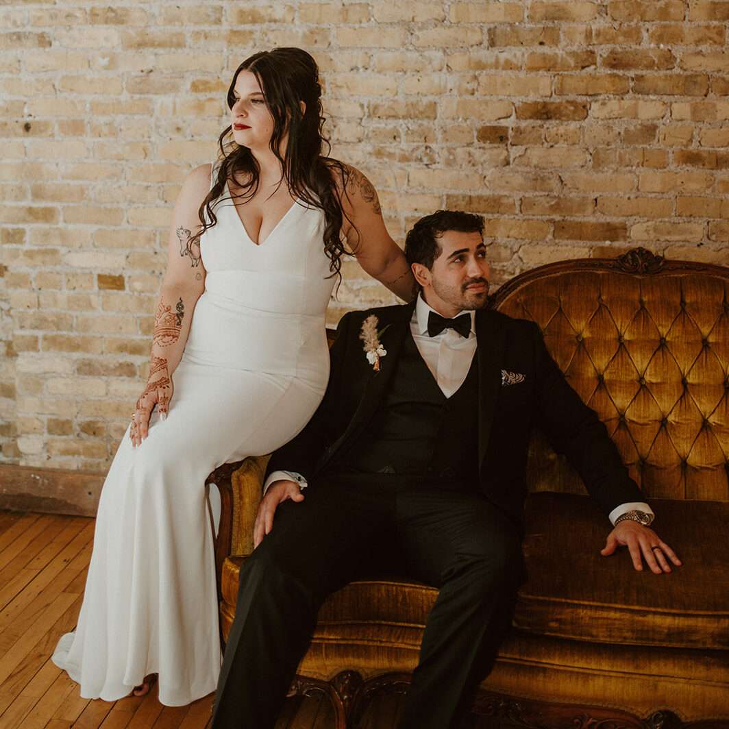 Couple poses in the front room at Mercantile Hall.