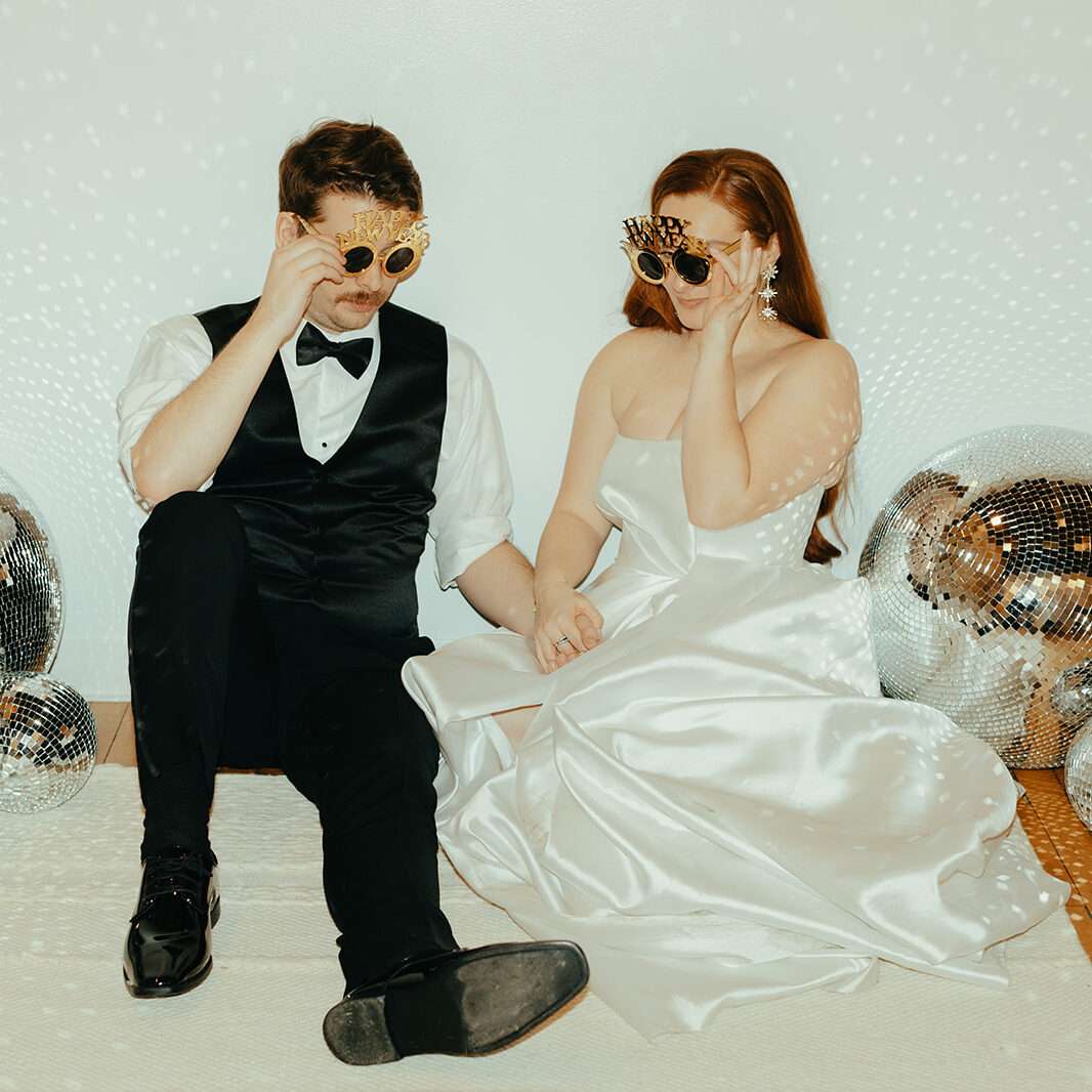 Newlyweds pose in the front room at Mercantile Hall.