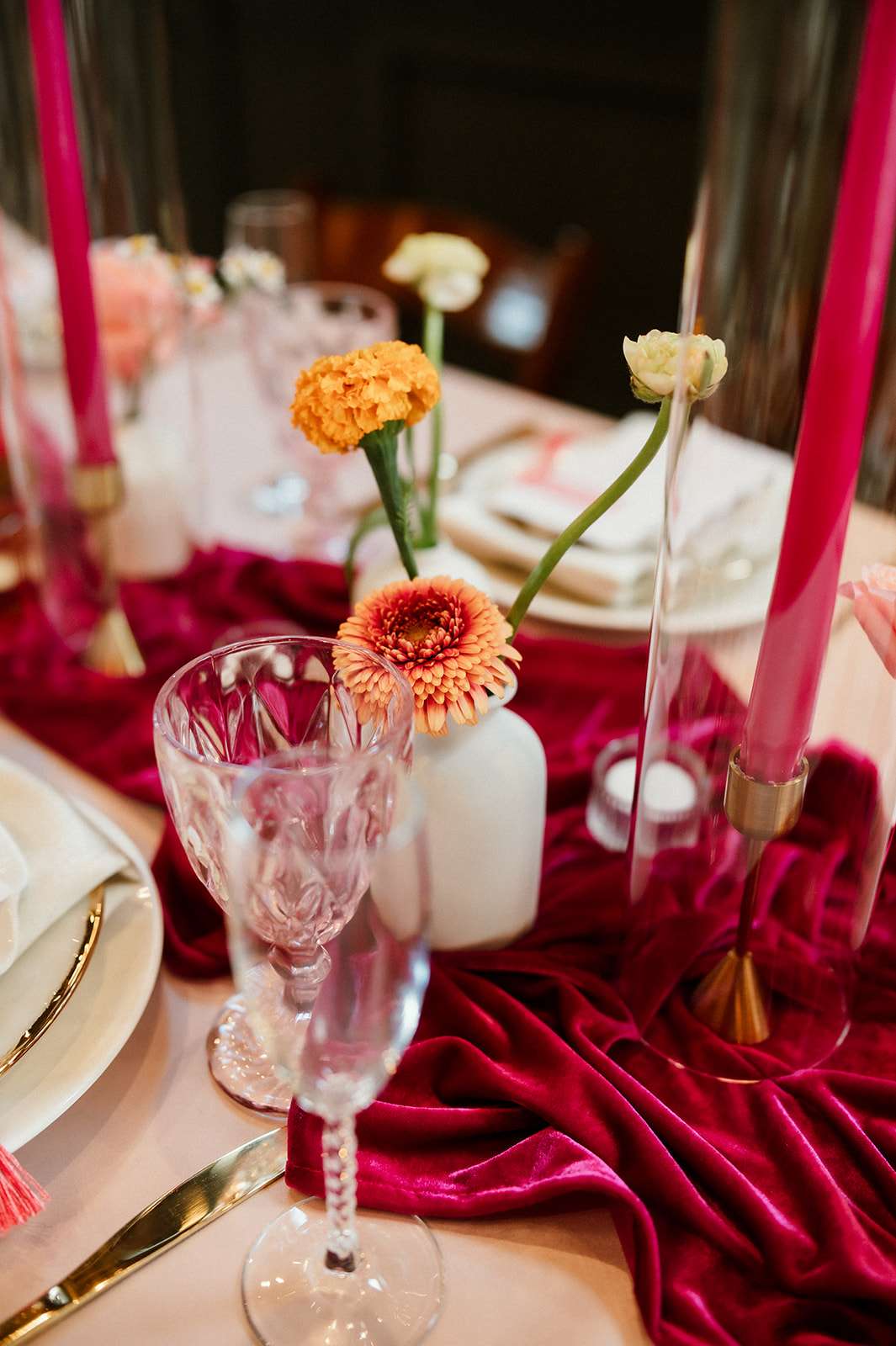 Colorful wedding reception table with bright florals and gold flatware at Mercantile Hall in Burlington, WI